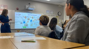 Students using a classroom visual to support a discussion.